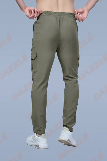 Green cargo pants worn by a person on a light gray background