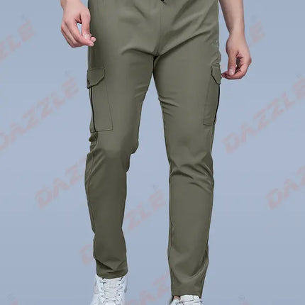 Person wearing olive green cargo pants on a gray background