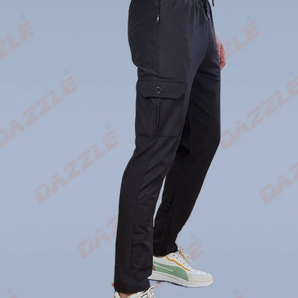 Person wearing black pants and white sneakers on a light blue background with 'Gazelle' branding.