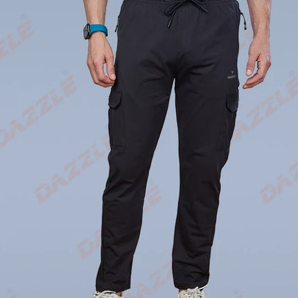 Person wearing black cargo pants on a light blue background