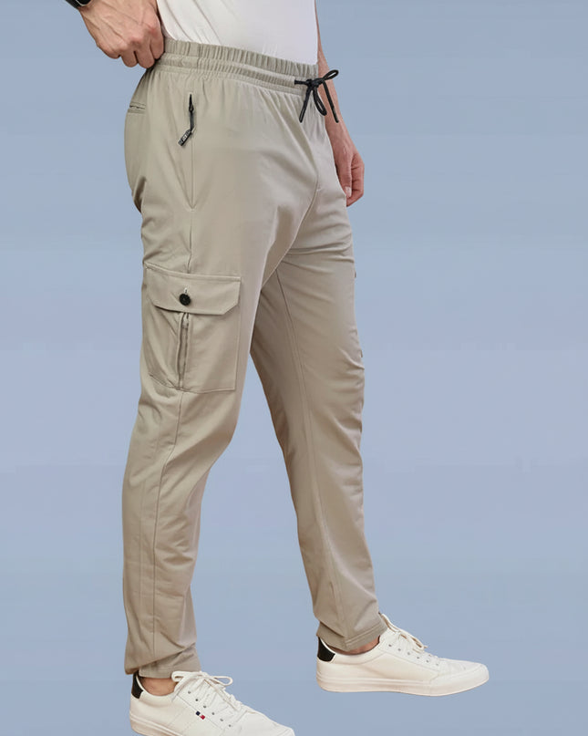 Beige pants worn by a person on a light blue background with Dazzle Sports Wear brand logo.