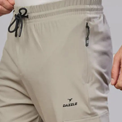 Beige pants with a visible brand logo on a plain background