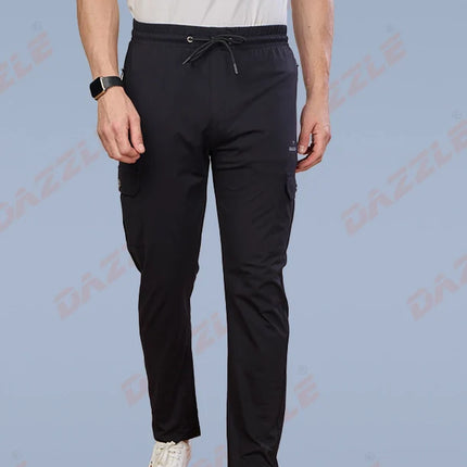 Person wearing black pants and white sneakers on a light blue background with 'Gazelle' branding.