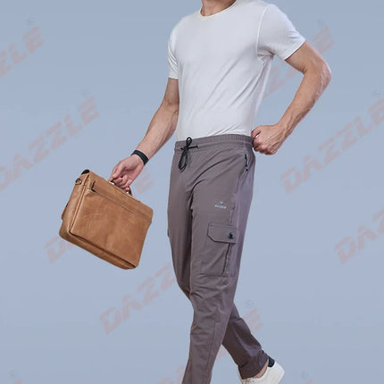 Man holding a brown leather bag against a light blue background