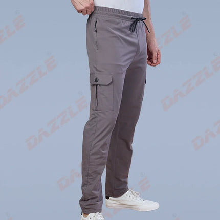 Person wearing gray cargo pants and white sneakers on a light blue background with 'Gazelle' branding.