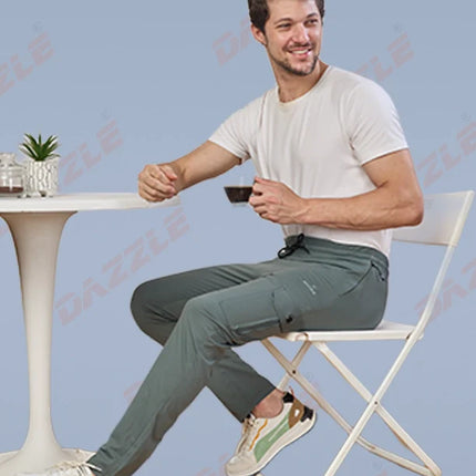 Man sitting on a chair holding a cup against a light blue background