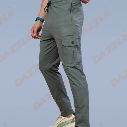 Person wearing green cargo pants and white sneakers on a light blue background